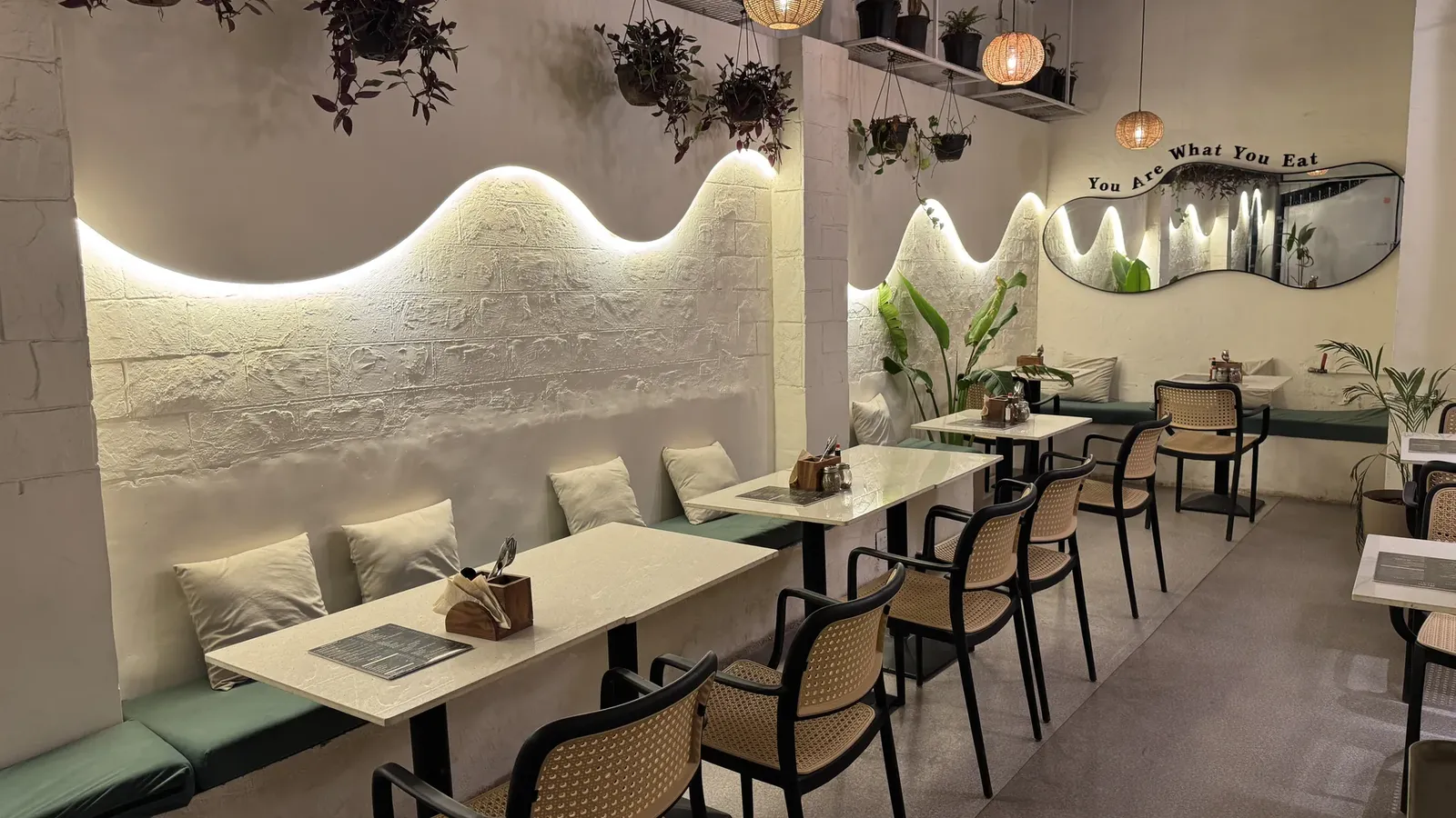Warm wave lighting and cane chairs in the Cafe Orelo dining room