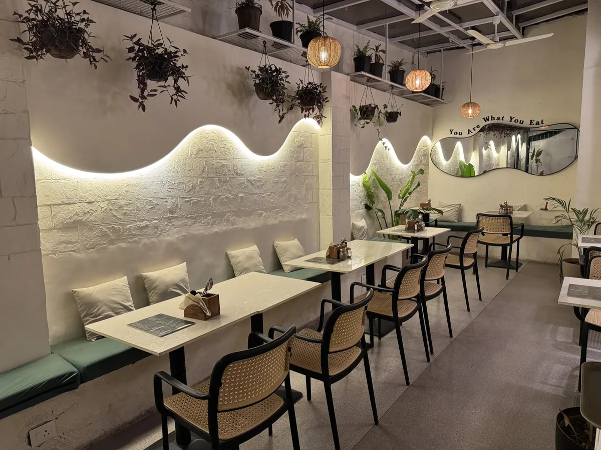 Warm wave lighting and cane chairs in the Cafe Orelo dining room
